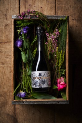  prosecco bottle in a box of flowers 