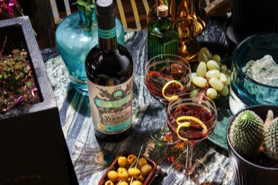  Bottle of vermouth with glasses in outdoor setting 