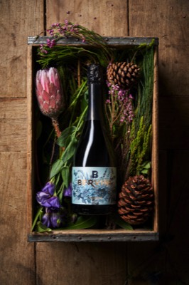  Bottle of sparkling wine in a wood box with flowers 